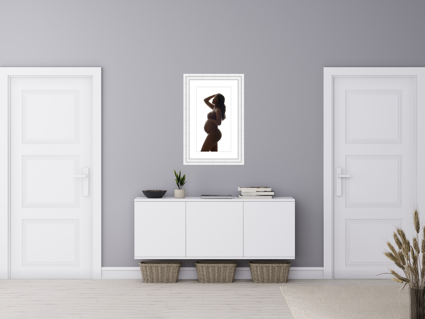 Perfectly framed maternity portrait hanging in a walkway of a stylish, modern home.